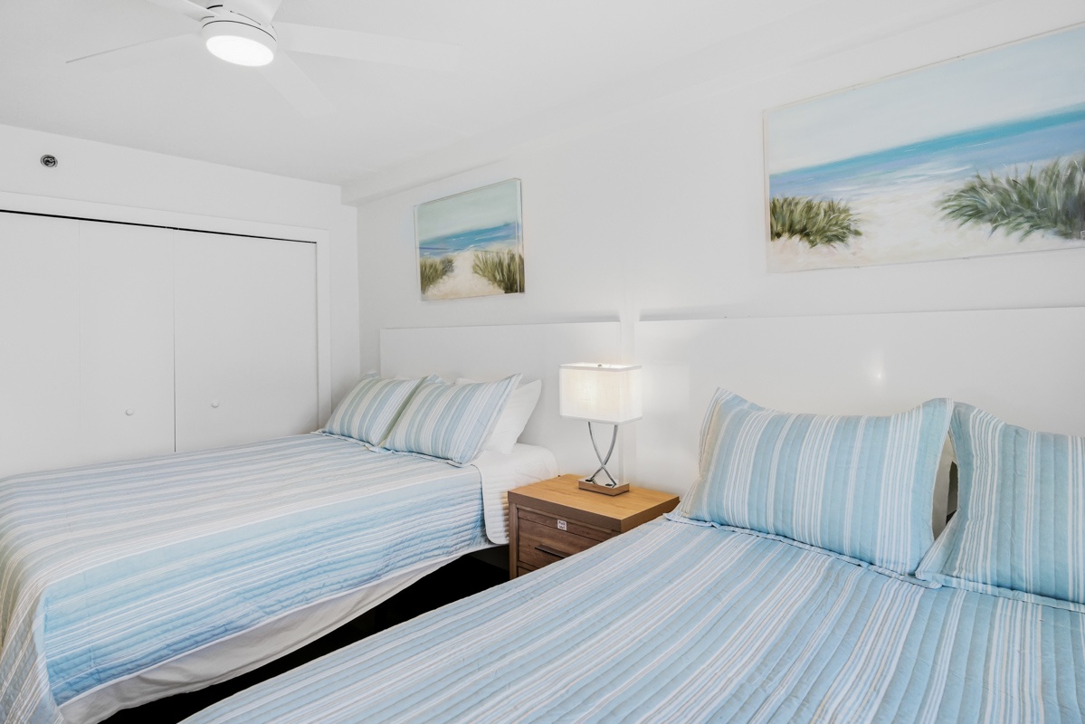 Drift into peaceful sleep surrounded by coastal charm in your 2 Queen bedroom, where ocean-inspired artwork and soft linens create a serene retreat.