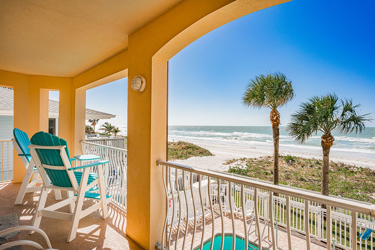 Wake up to ocean waves from your private balcony, where turquoise chairs await your morning coffee with endless sea views.