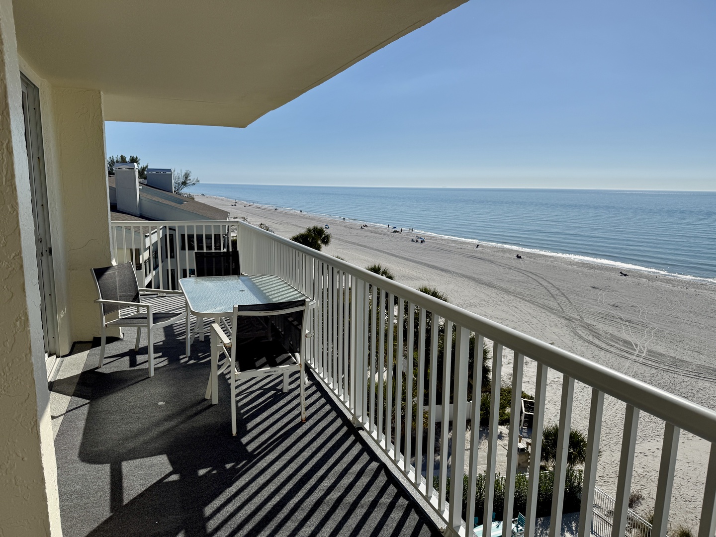 Your private balcony overlooks pristine sandy shores where you can sip morning coffee while watching waves roll in.