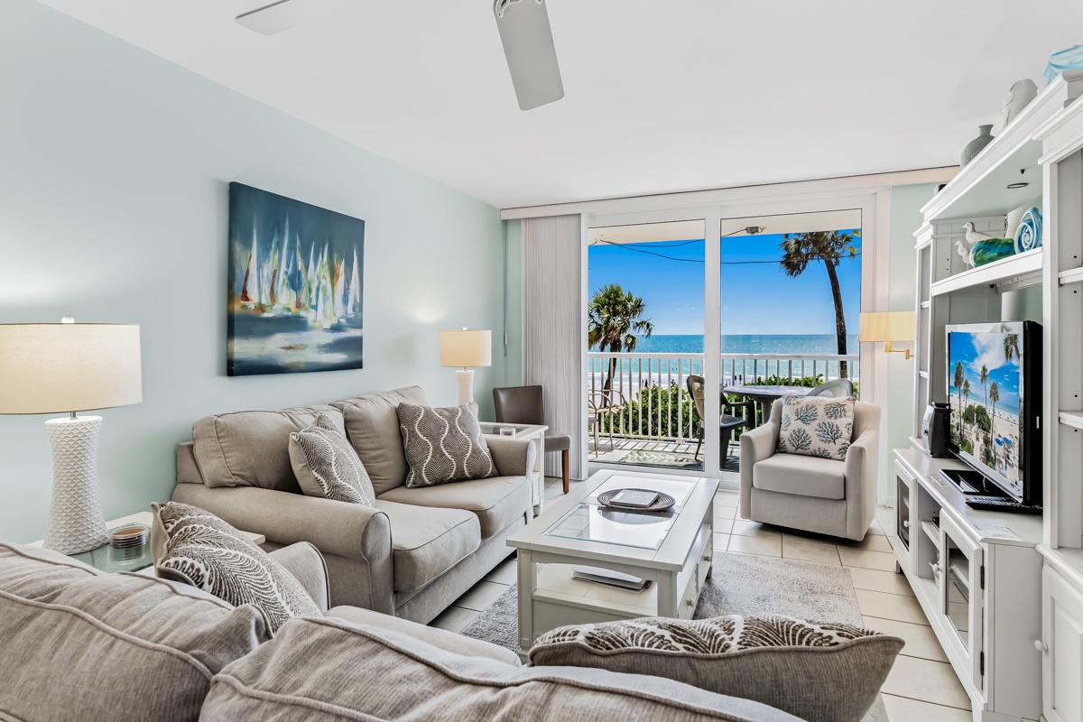 Settle into your bright, beach-inspired living space where calming coastal tones meet plush comfort. Step outside to the balcony and enjoy unobstructed ocean views framed by swaying palms—your perfect retreat.