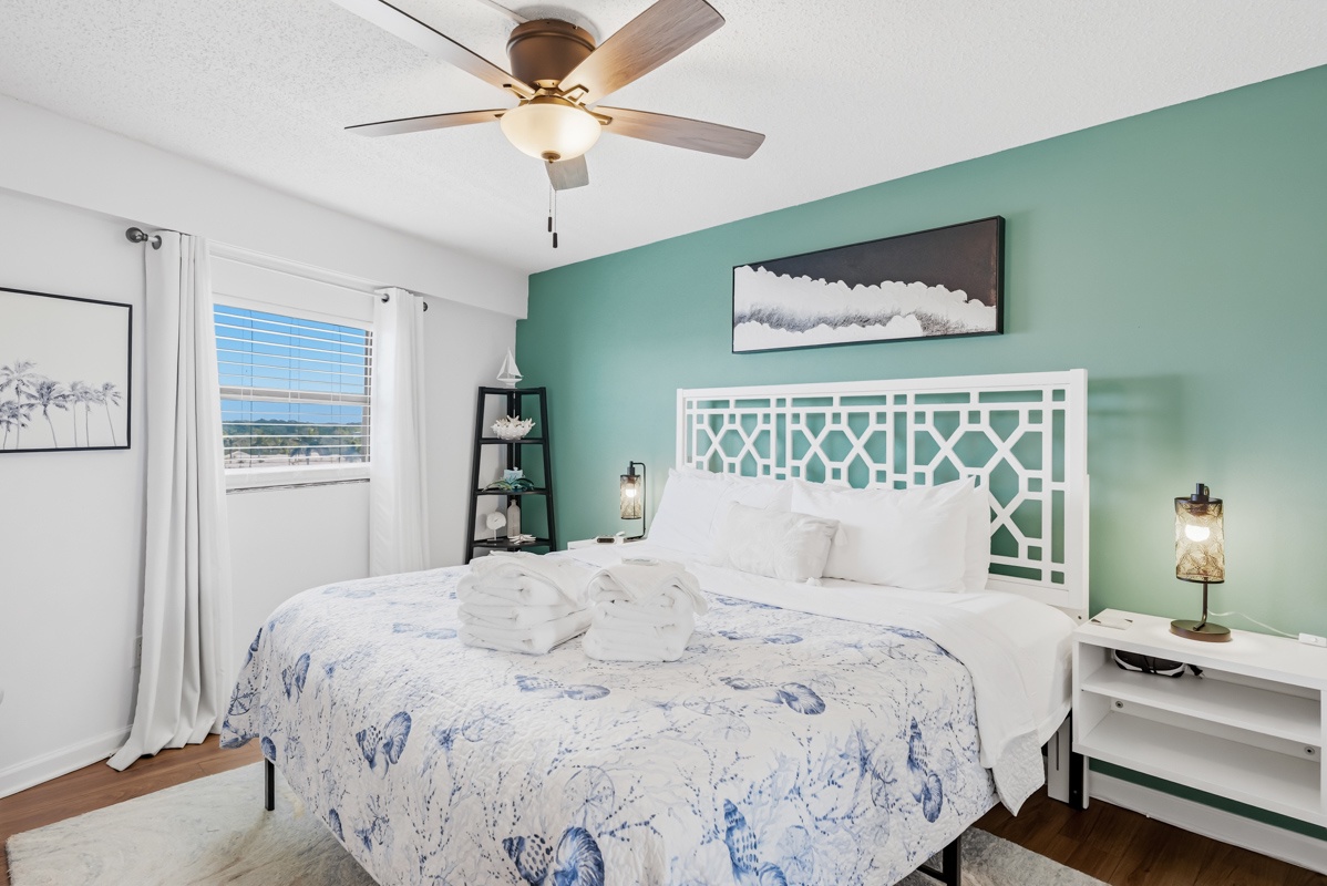 King size spacious bedroom with ceiling fan and smart TV