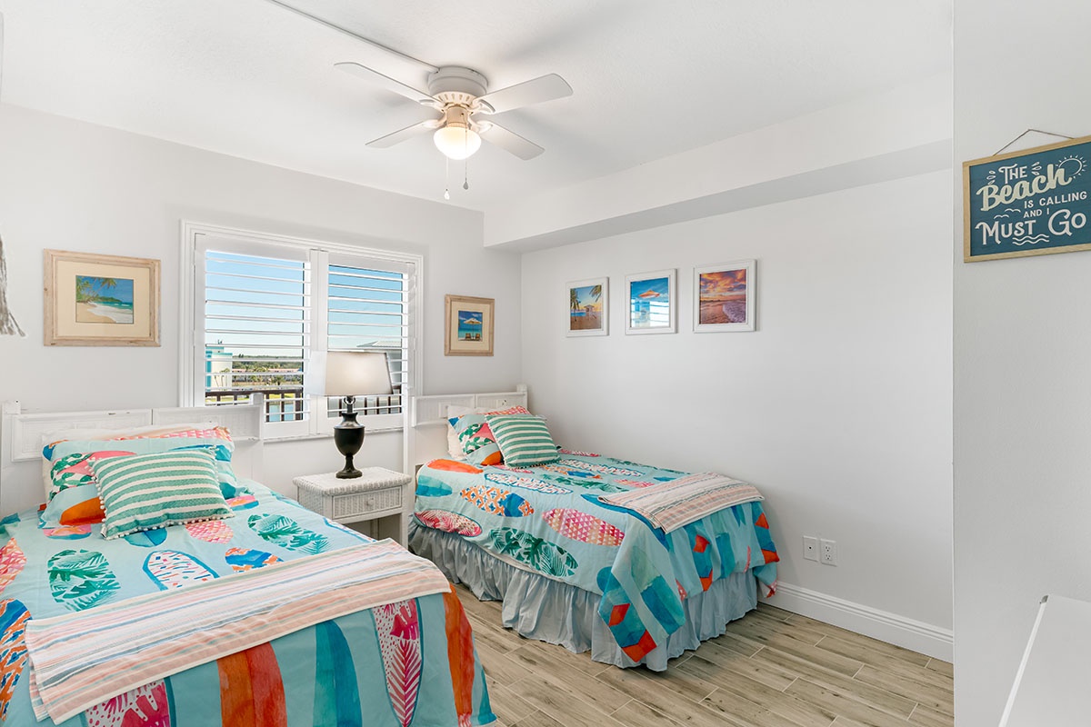 Drift off to sleep in your cheerful twin bedroom, where coastal artwork and vibrant linens create the perfect beachside retreat.
