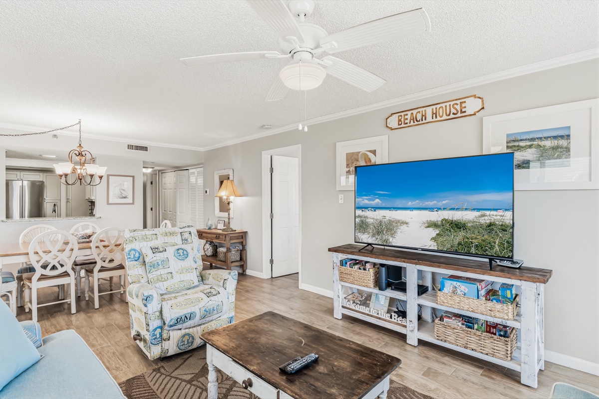 Your beach-themed retreat features coastal decor, cozy seating, and a large TV for relaxing evenings after sun-soaked days.