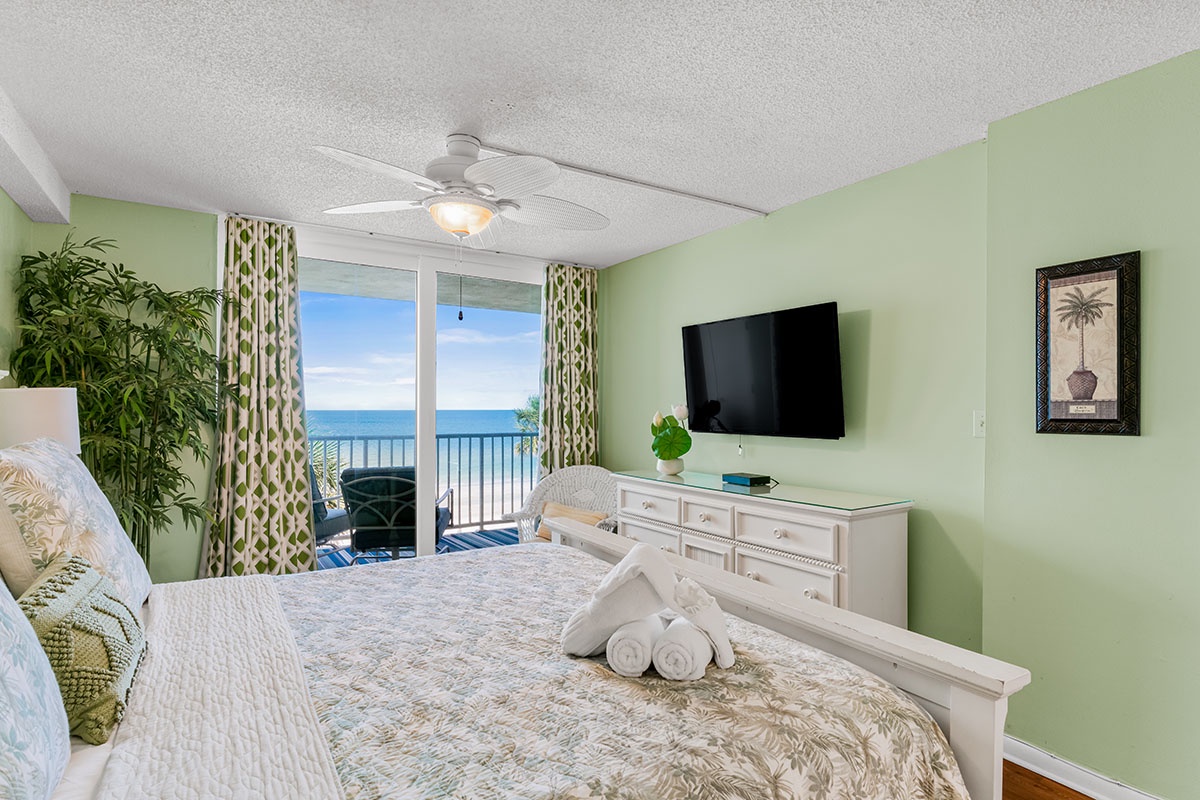 Wake up to stunning ocean views from your tropical bedroom sanctuary with comfortable bedding and beachfront balcony access.