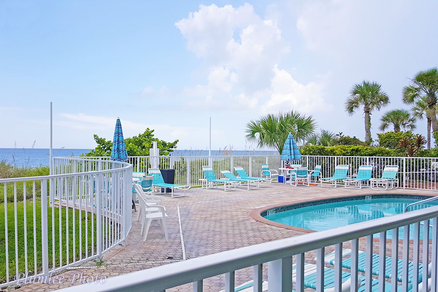 The pool deck and view of the beach in the background.