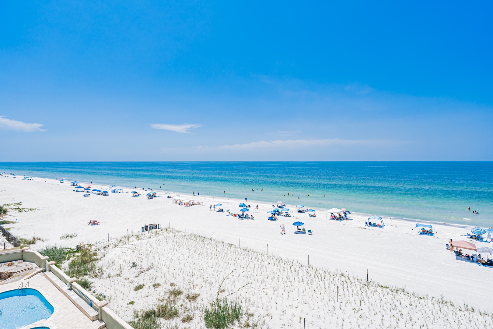 The property sits on a pristine stretch of white-sand beach, where turquoise waters and endless blue skies create a perfect coastal retreat for your vacation.