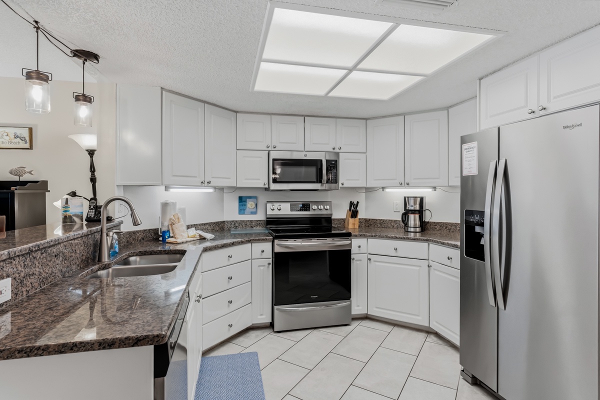 The fully equipped kitchen invites you to cook with ease on granite counters, stainless appliances, and bright, modern finishes that make every meal feel effortless.