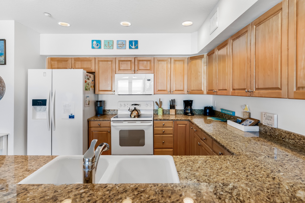 Your fully equipped kitchen awaits with granite countertops, stainless appliances, and everything you need to create memorable vacation meals together.