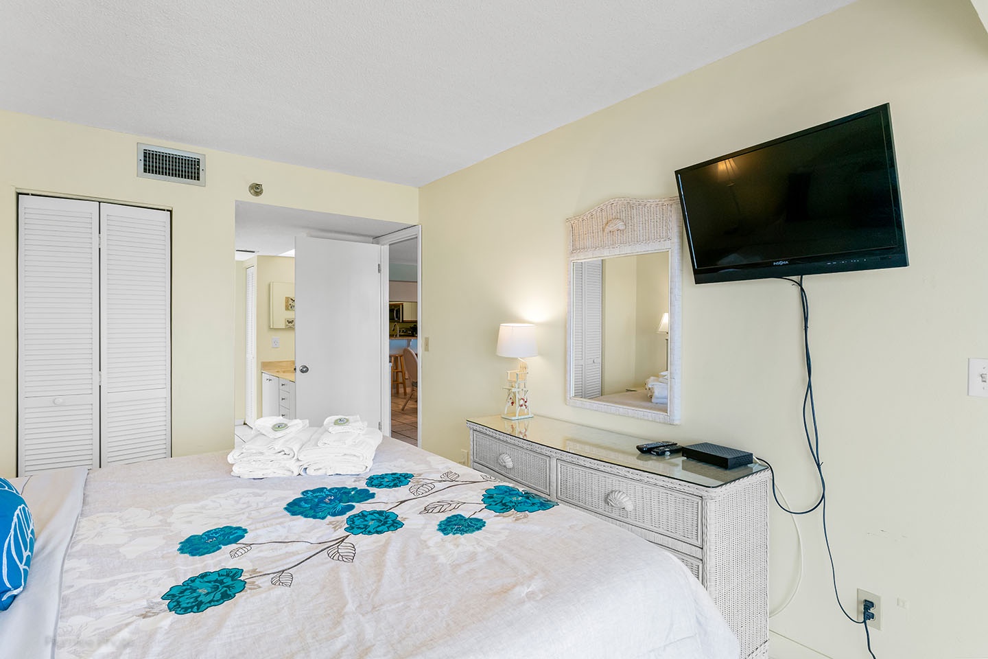 The TV and a door leading to the ensuite master bath.