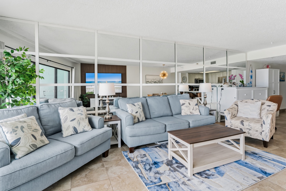 Sink into plush coastal seating with ocean views welcoming you through the windows—your perfect place to unwind after days spent exploring the shore.