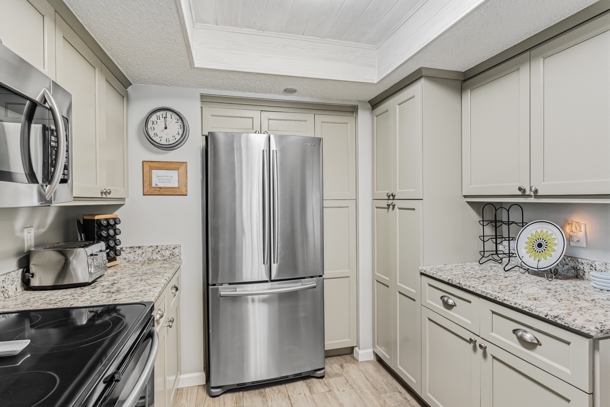 Your fully-equipped kitchen invites you to cook and gather with sleek stainless appliances, ample counter space, and elegant cabinetry ready for your stay.