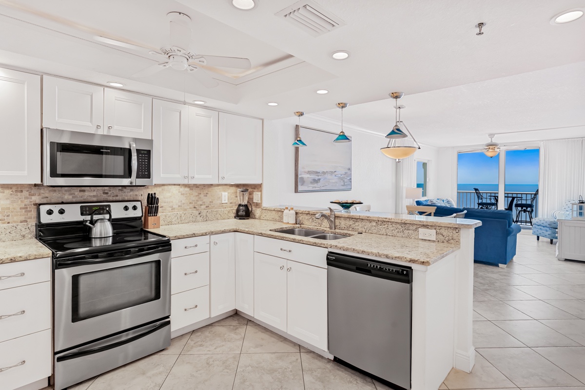 Your fully equipped kitchen opens to stunning ocean views, with granite counters and modern appliances for memorable vacation meals.