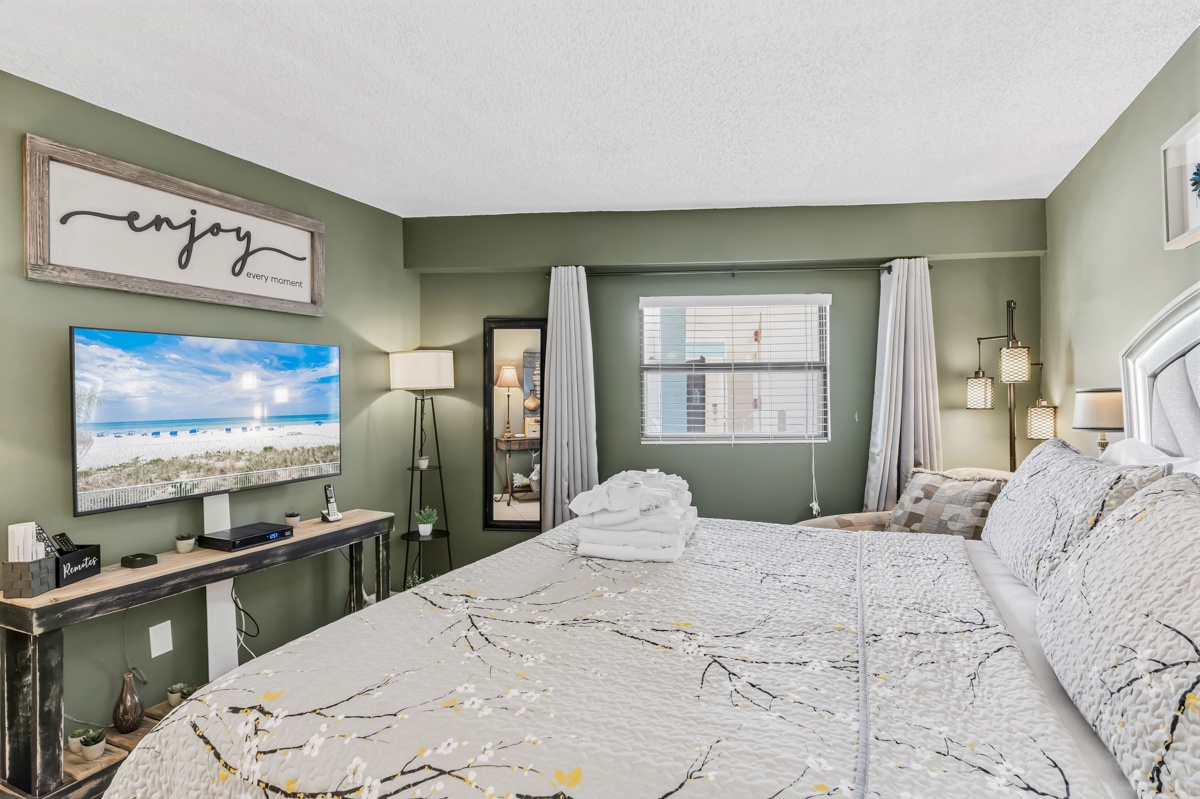 Unwind in your restful bedroom with calming sage walls, plush bedding, and modern amenities. Watch the waves on the flat-screen TV or simply relax in your peaceful coastal retreat.