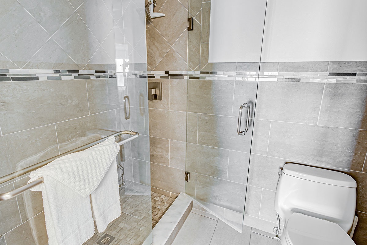 Glass shower door for tiled shower
