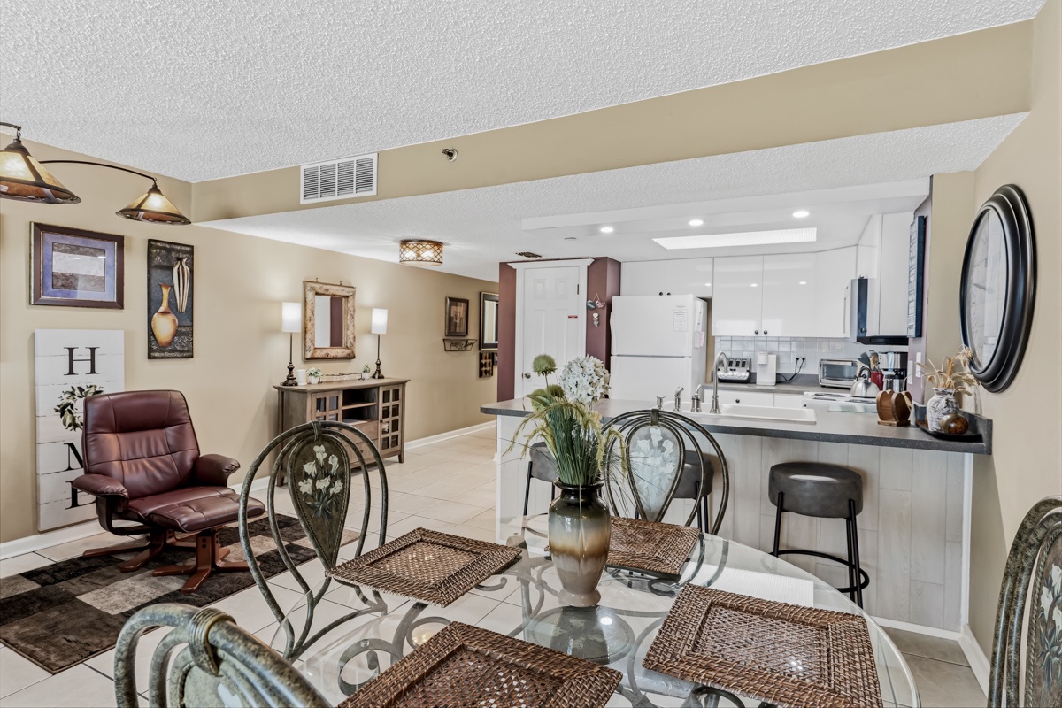Your open-concept living space flows seamlessly from dining to kitchen—bright, welcoming, and designed for comfort with stylish furnishings, soft lighting, and plenty of room to unwind.