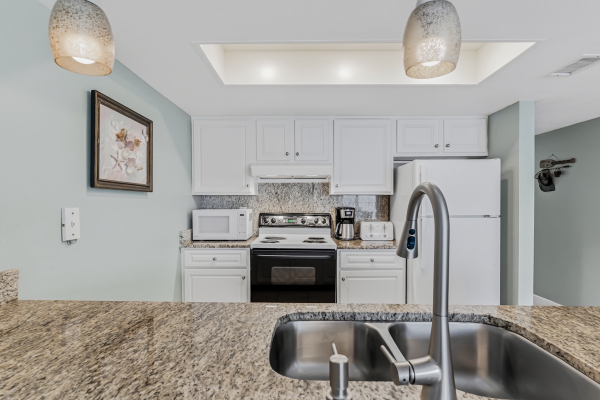 Step into your fully equipped kitchen with sleek granite counters, modern appliances, and everything you need to whip up a home-cooked meal. Bright pendant lighting and crisp white cabinetry make cooking feel effortless.