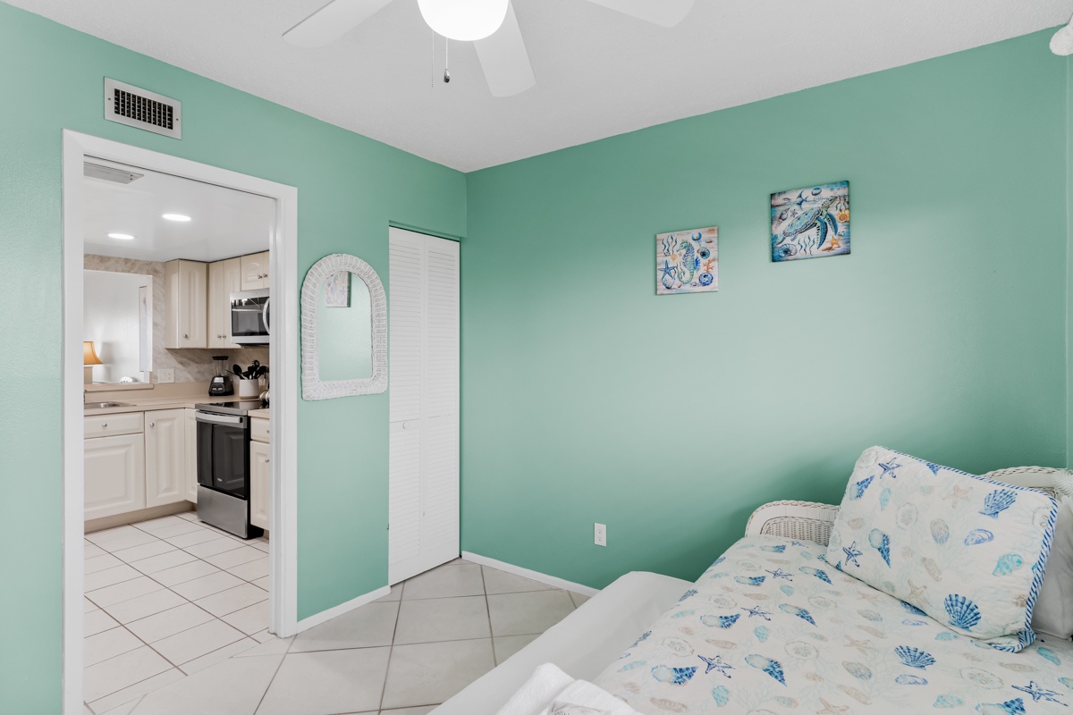 Your tranquil bedroom features soothing seafoam walls and coastal-themed bedding, creating the perfect seaside retreat for restful nights.