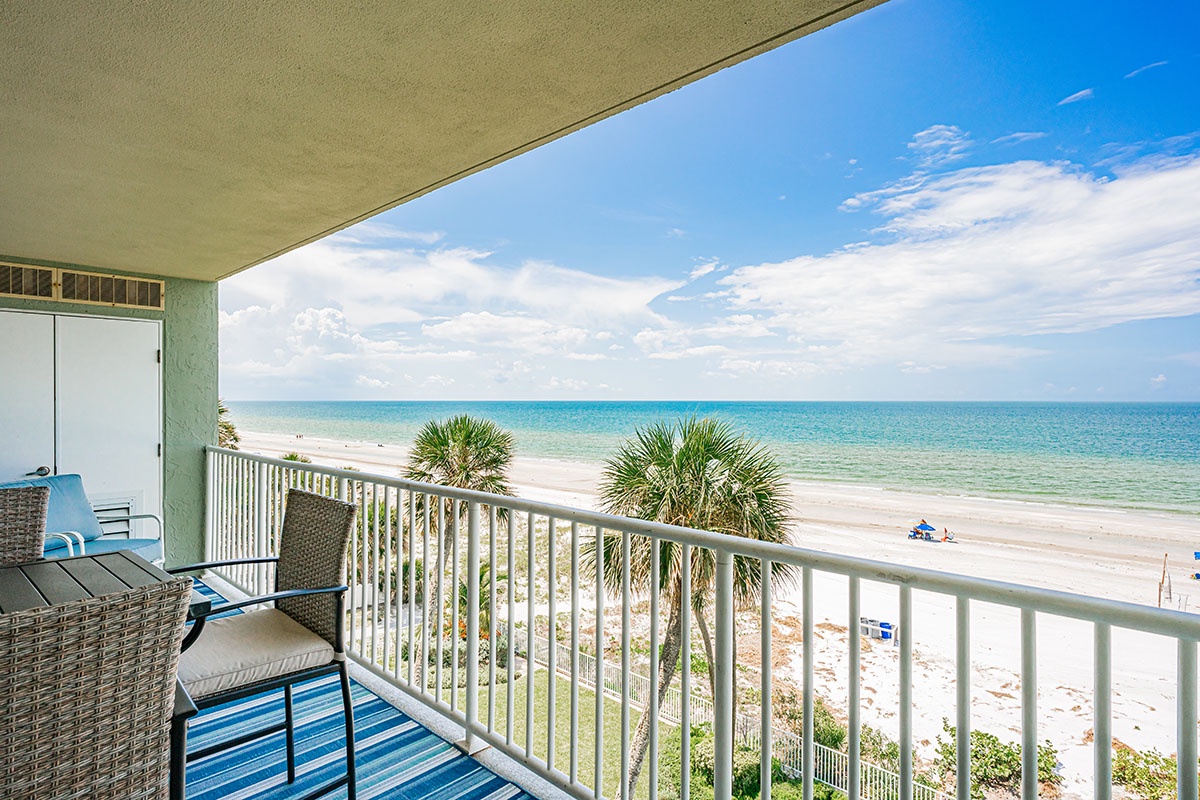 Unwind on your private beachfront balcony with stunning ocean views and comfortable seating for the perfect coastal retreat.