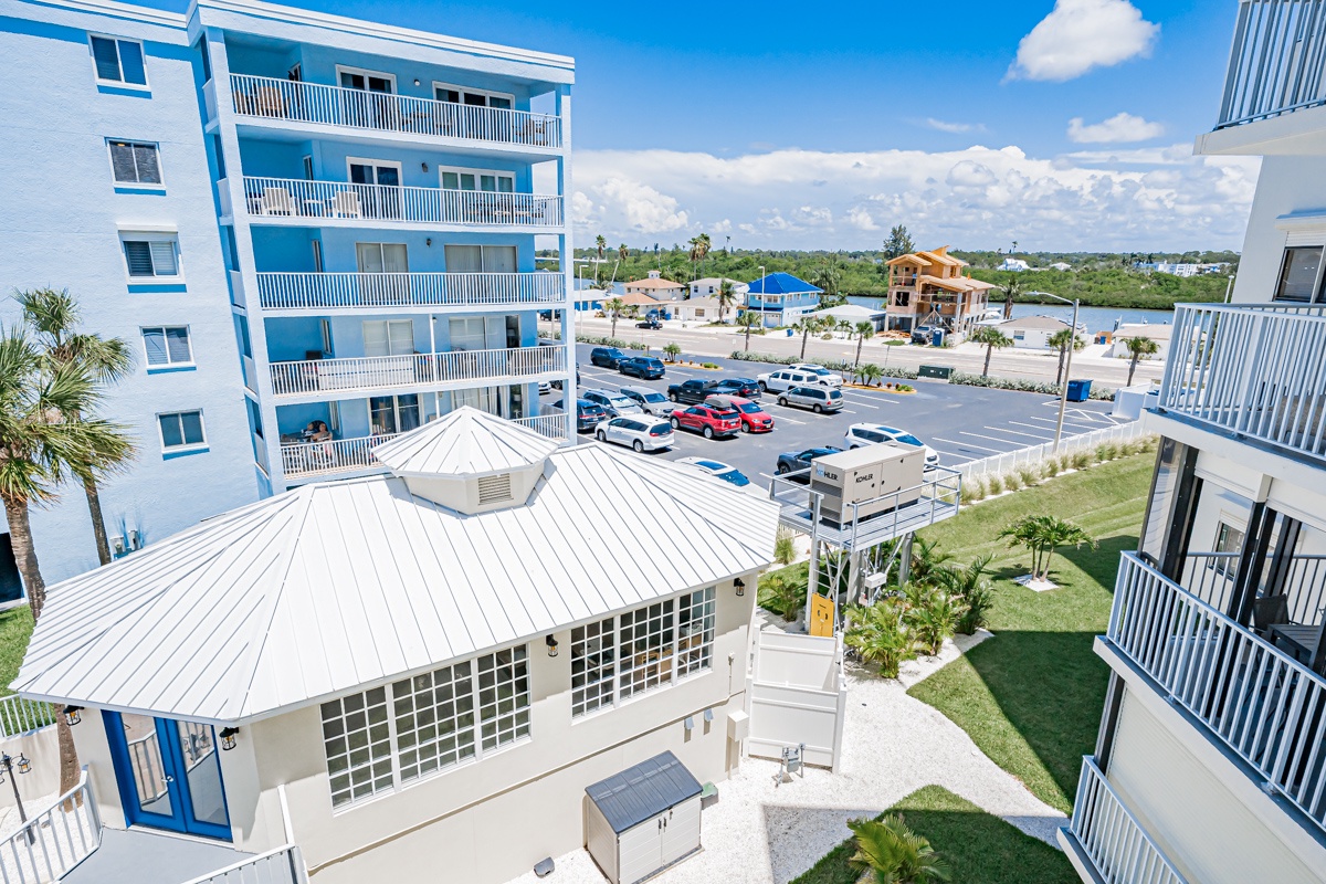 The property is located in a peaceful coastal neighborhood with convenient parking and tropical landscaping throughout the grounds.