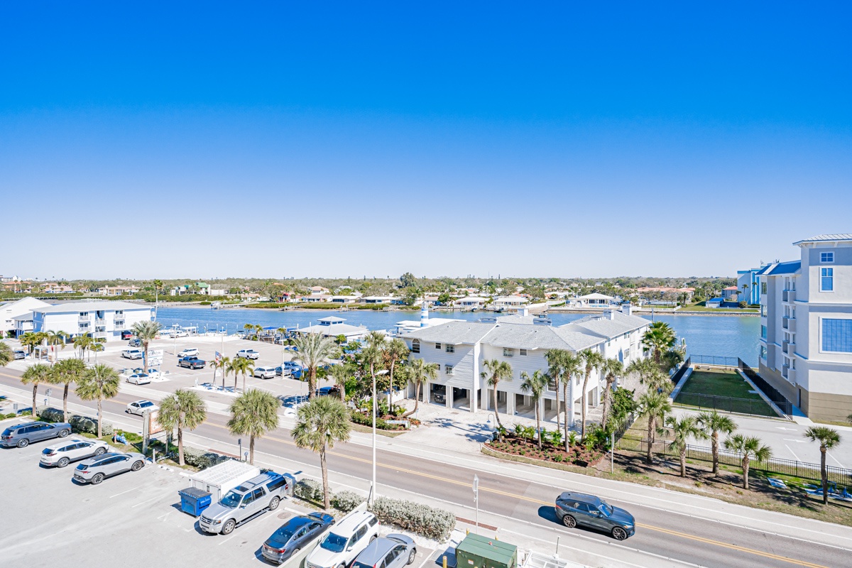 View from front door and bedrooms with palm-lined grounds and a scenic coastal setting.