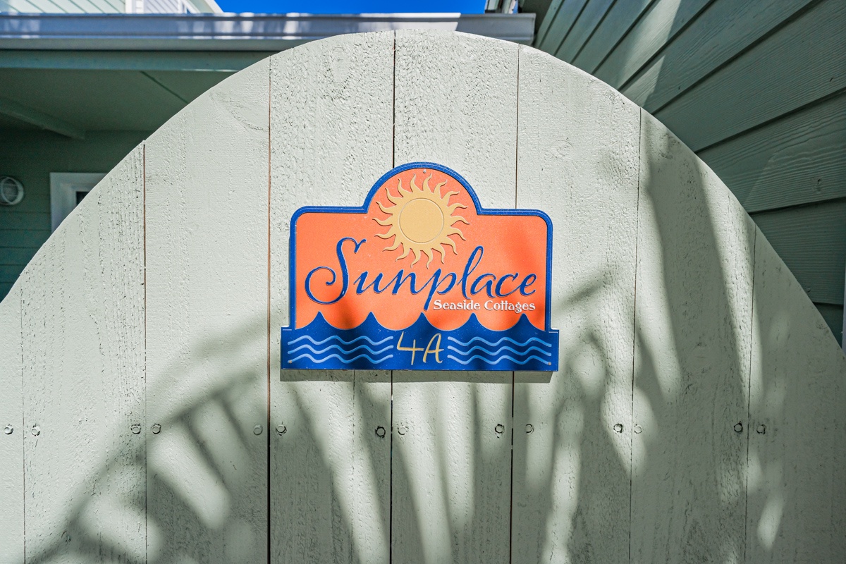 Welcome to Sunplace Ashore Beachside, where your coastal retreat awaits behind this charming entrance gate.