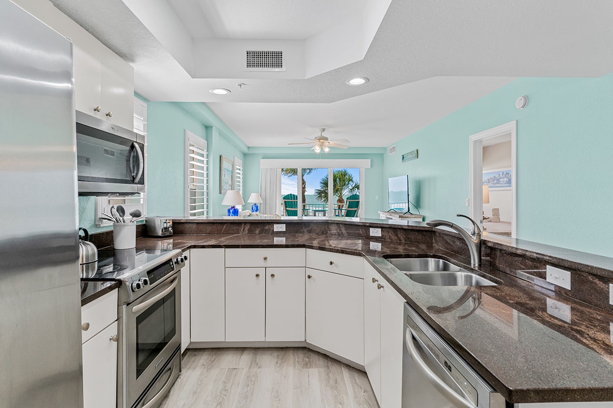 Your fully equipped kitchen with granite counters and tropical views invites you to cook while the ocean breeze flows through.