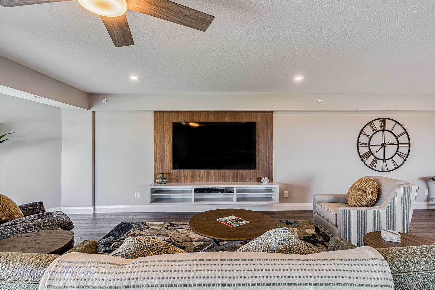 Living room has a large, wall mounted smart TV.