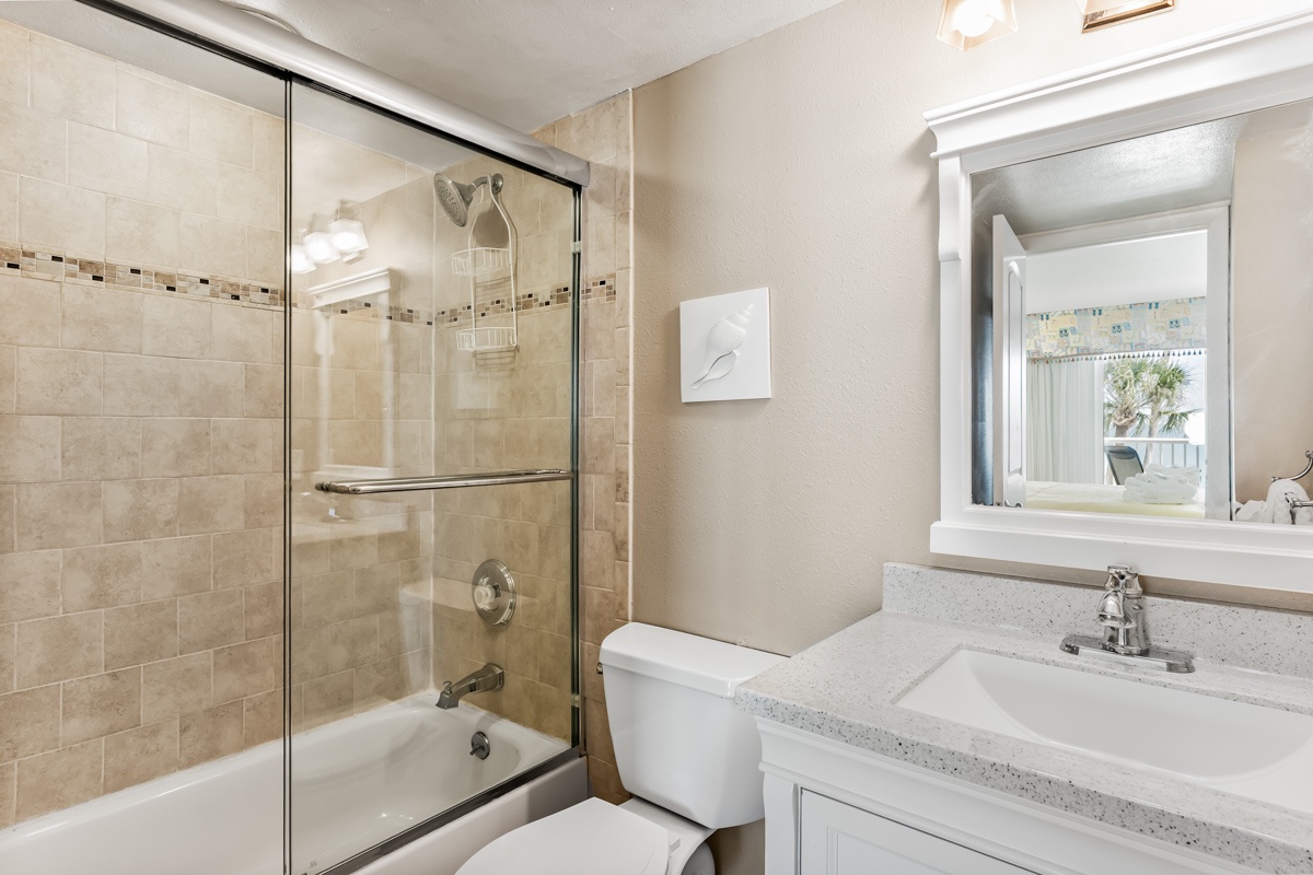 Your spa-inspired bathroom features elegant tile work, a sparkling glass-enclosed tub, and polished fixtures that invite you to refresh and recharge.