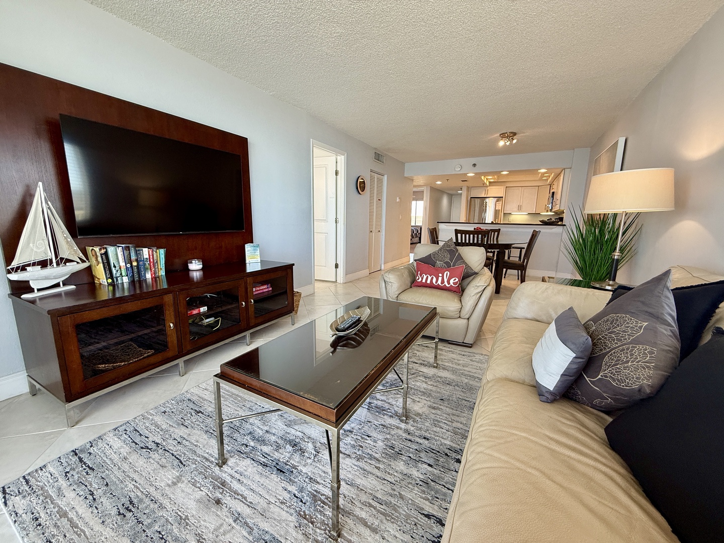 Sink into plush sectional seating while enjoying your entertainment center and open-concept layout connecting seamlessly to your modern kitchen.