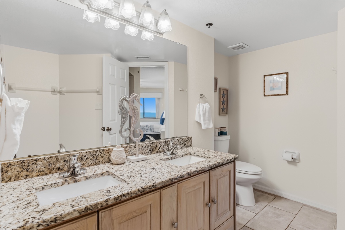 Freshen up in your spacious bathroom with elegant granite countertops, dual sinks, and coastal-inspired décor that makes every moment feel like a retreat.