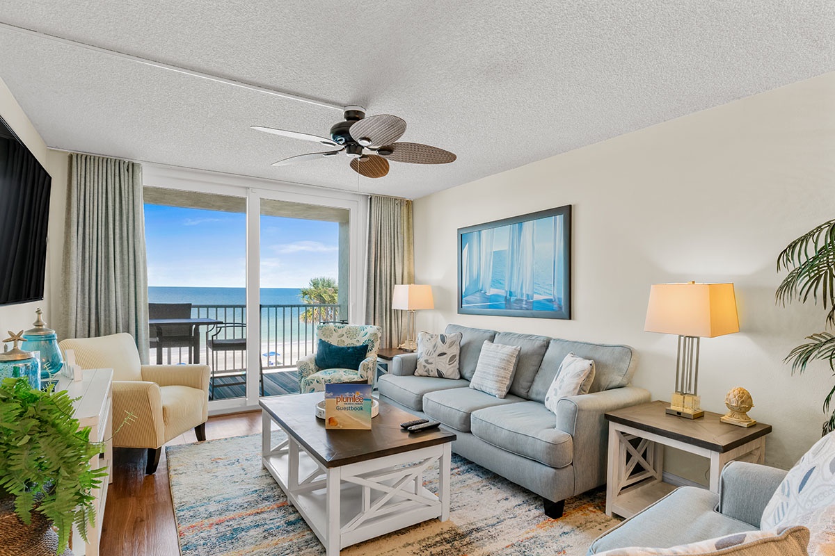 Relax in your bright living room with sea views, where gentle ocean breezes flow through sliding doors onto your private balcony.