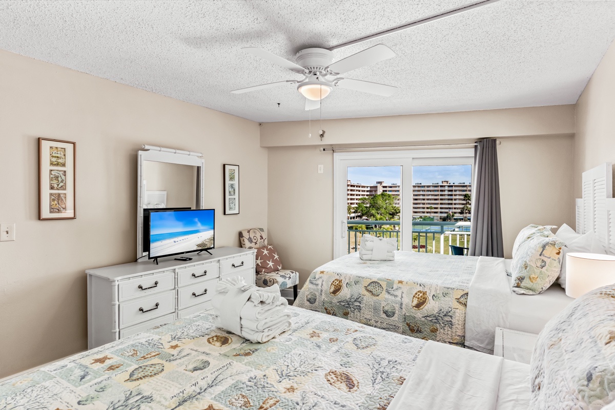 Wake up to gentle ocean breezes in your serene bedroom, where twin beds and charming coastal décor create the perfect seaside retreat.