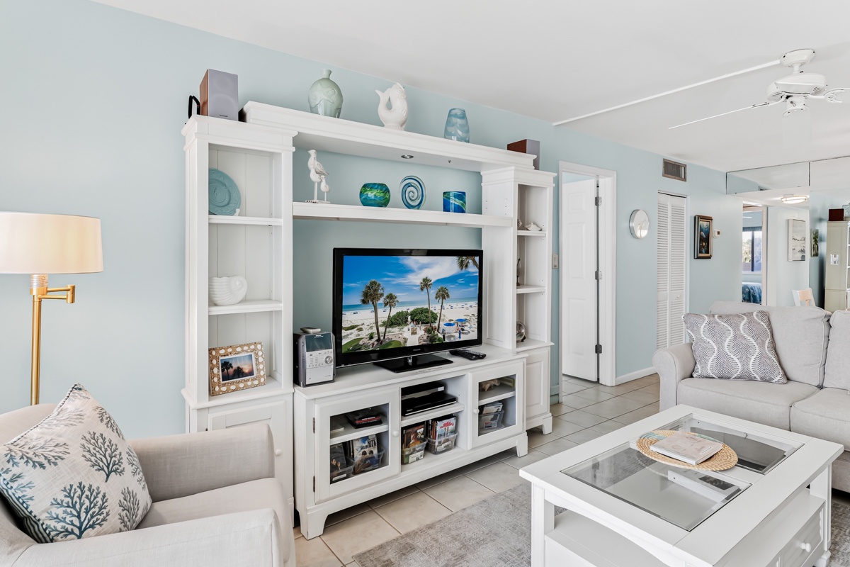 Sink into the plush sofa and unwind in your bright, coastal-inspired living room. Soft blues and whites create a calming retreat perfect for relaxing after beach days.