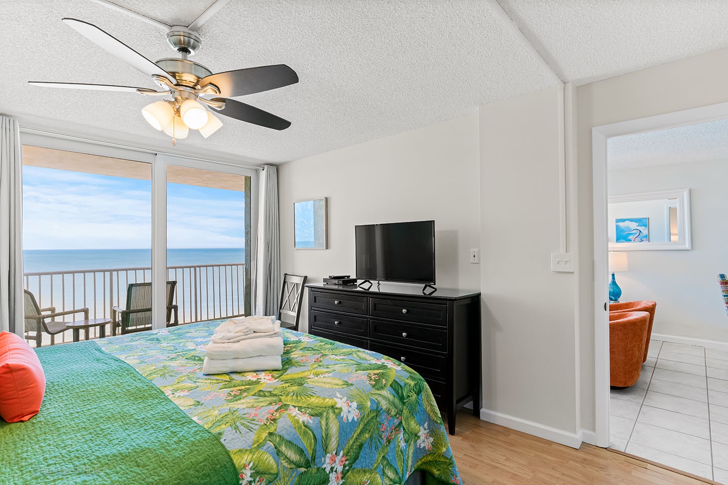 King bedroom has ceiling fan and TV