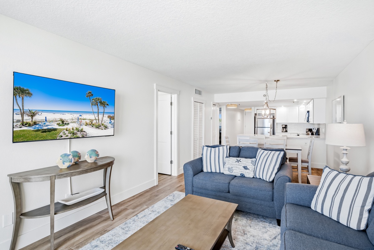 Relax in your bright living space with coastal décor, modern kitchen, and beachy vibes that make you feel instantly at home.