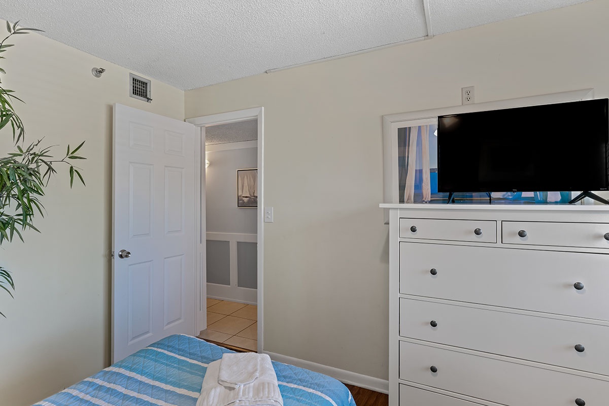 Your bright bedroom offers comfortable sleeping quarters with climate control, a flat-screen TV, and ample dresser storage. Fresh linens and a private entry-view add to the comfort.