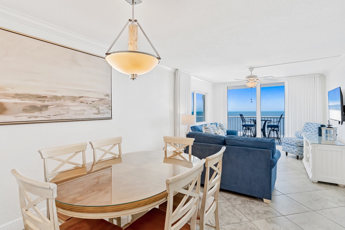 Bright oceanfront living space where you'll dine with stunning sea views through floor-to-ceiling windows and relax in coastal comfort.