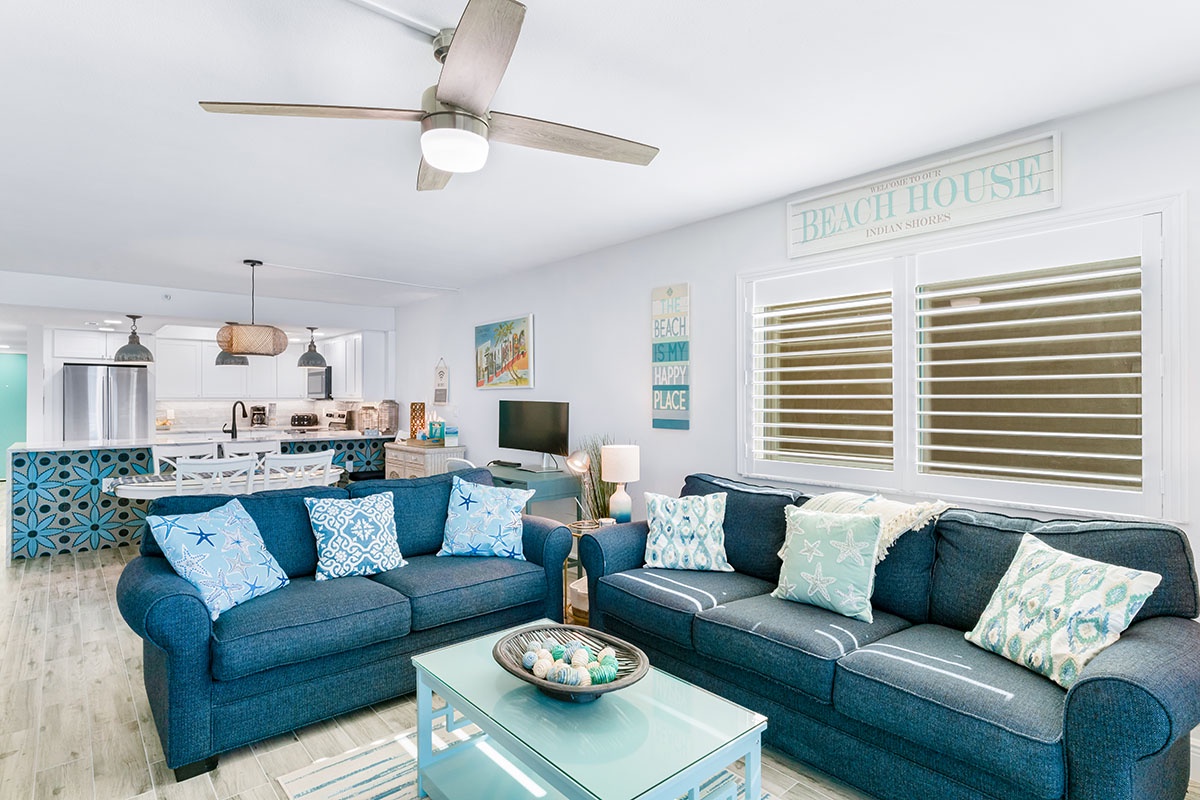 Sink into plush coastal sofas while ocean breezes flow through your bright, airy living space—perfectly designed for relaxation.