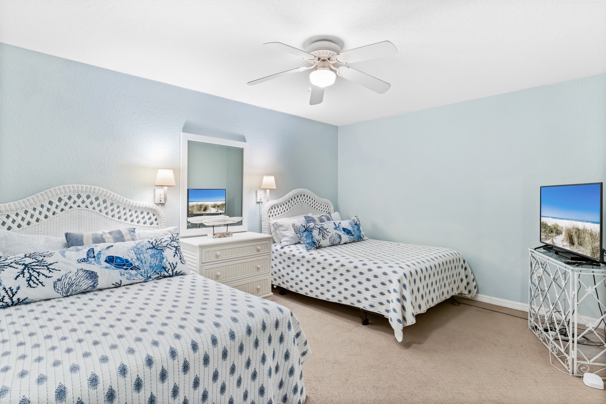 Drift into peaceful sleep in this coastal-inspired twin bedroom with ocean-themed linens and your own entertainment center.