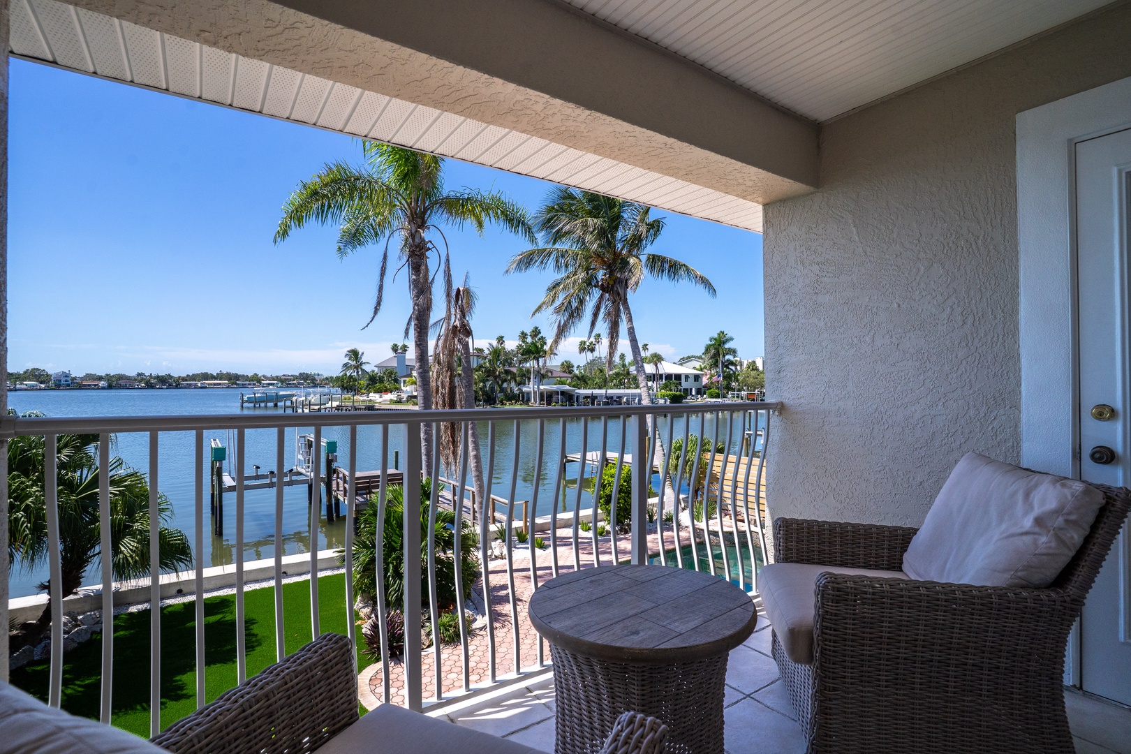 Your private balcony offers stunning water views where you can sip morning coffee while watching boats glide past swaying palms.