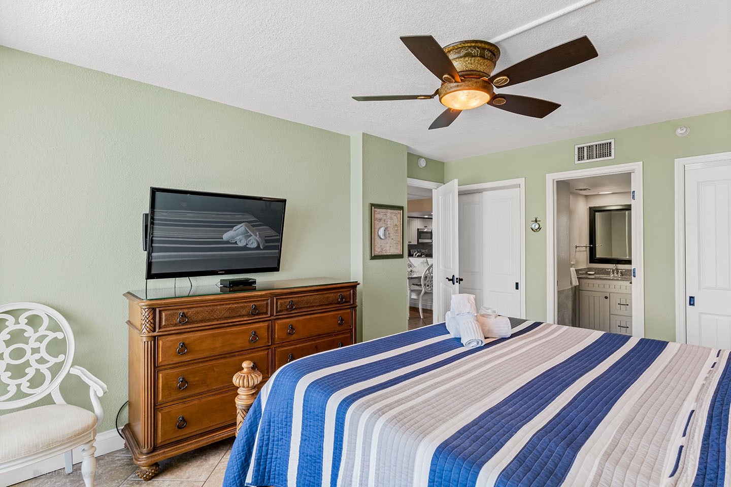 Master bedroom has TV and ceiling fan