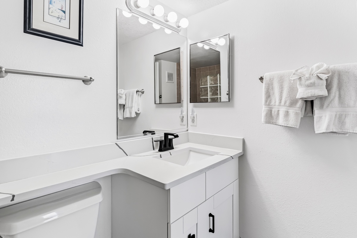 Freshen up in your own beautifully updated bathroom, complete with modern fixtures, bright vanity lighting, and plush towels ready for your arrival.