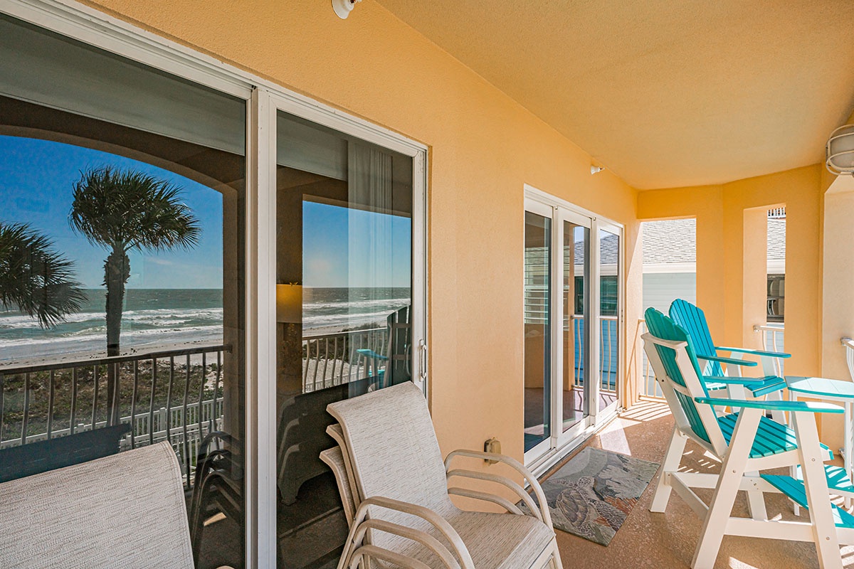 Your private balcony offers front-row seats to endless ocean views, with comfortable seating to watch waves roll in.
