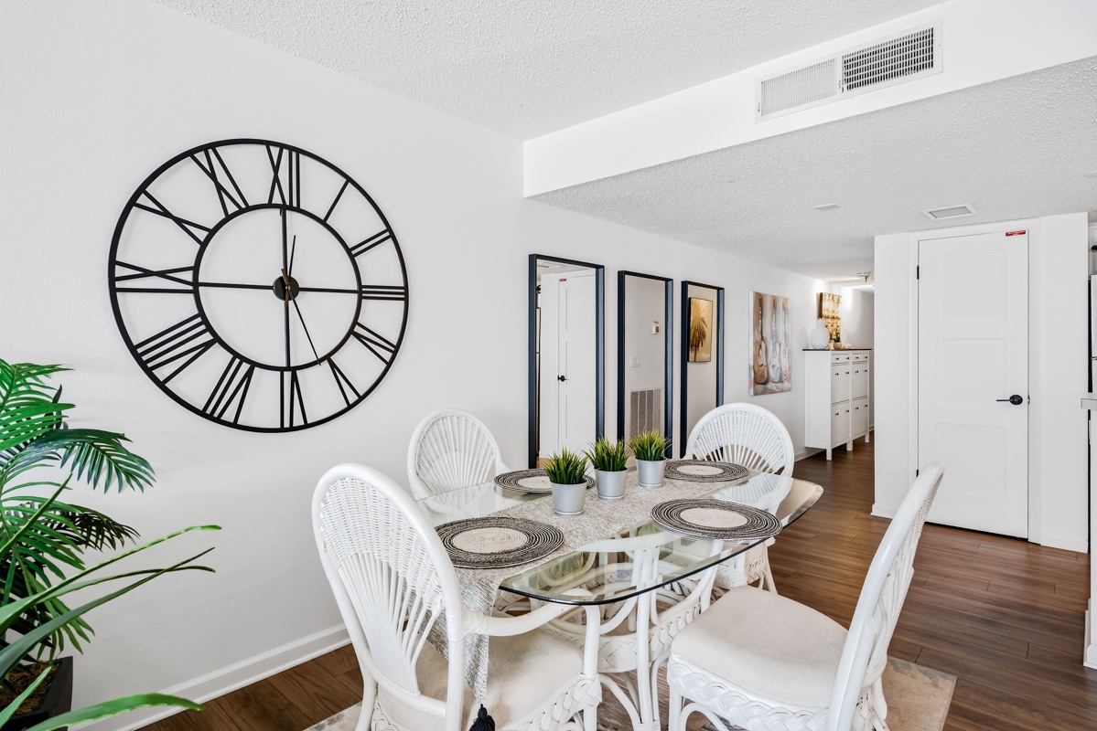 Gather around your coastal glass dining table, beautifully set for memorable meals in this bright, airy space.
