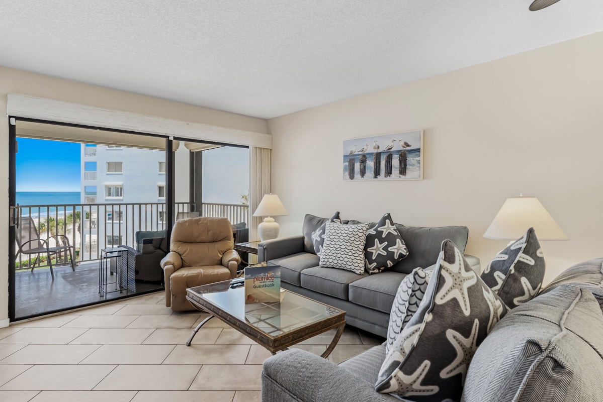 Unwind in your coastal haven, where plush seating and an open balcony invite you to soak in stunning sea breezes and the gentle sound of waves just beyond your door.