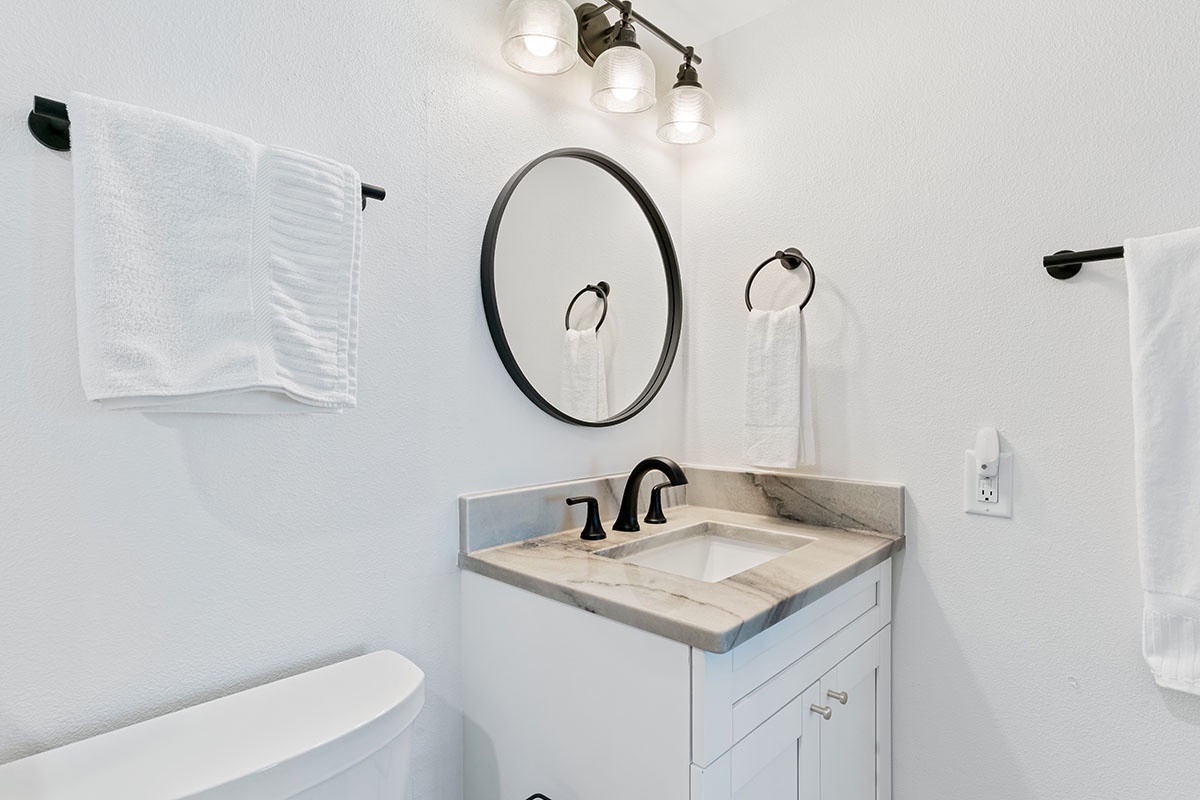 Your private bathroom features elegant marble countertops, modern fixtures, and fresh towels ready for your stay.