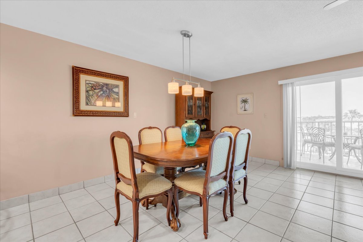 Gather around this elegant dining table for meals with loved ones, sharing laughter and creating memories in a bright, welcoming space that flows seamlessly to your private balcony retreat.