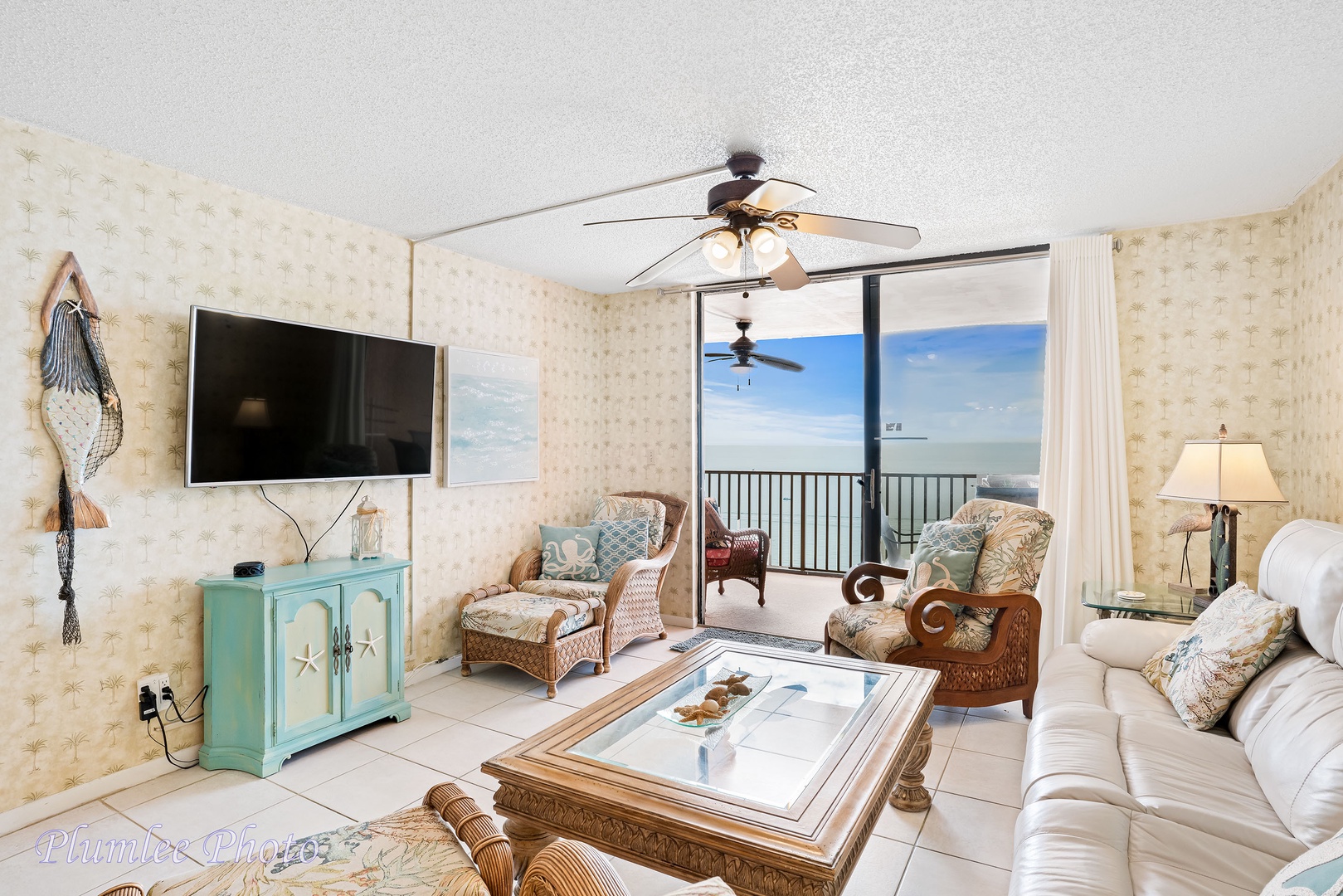 Living room has ceiling fan and TV with DVD player