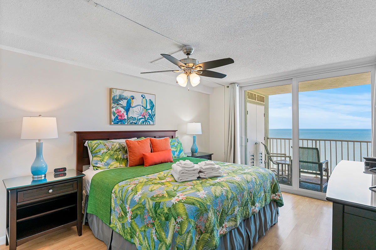 Wake up to stunning ocean views from your comfortable bedroom, where tropical decor and fresh linens create the perfect coastal retreat.