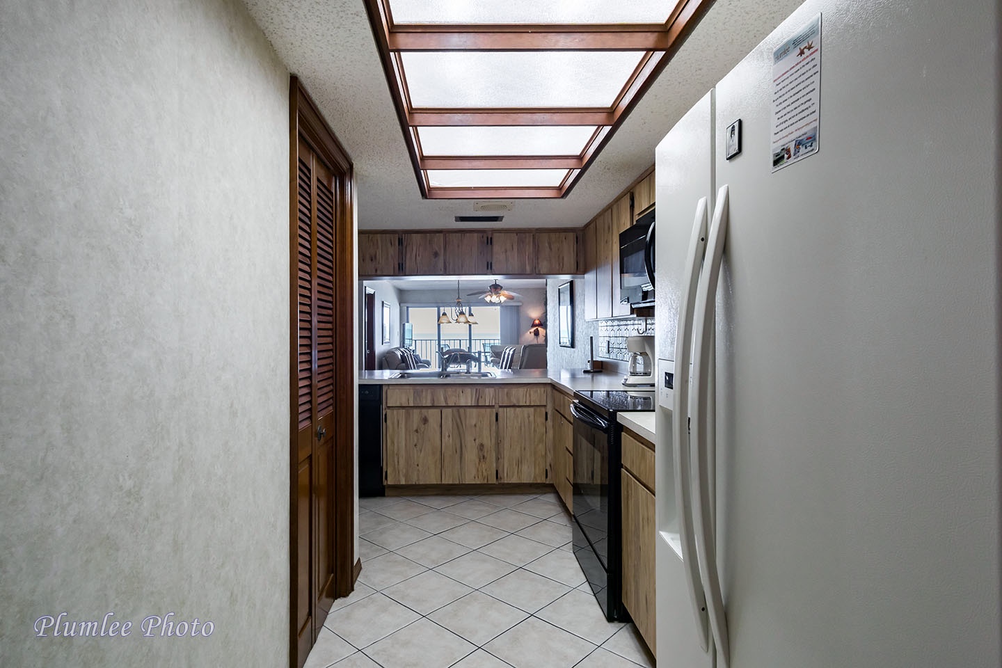 Looking through the Kitchen all the way to the view of the beach in the Living Room.